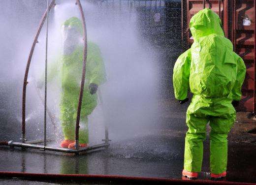 workers-in-radiation-suits-wash-off-contaminants